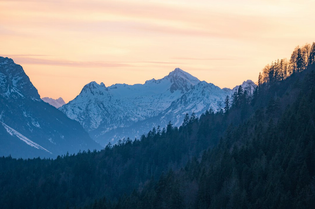 Snow-capped mountain peaks in the Alps at sunrise