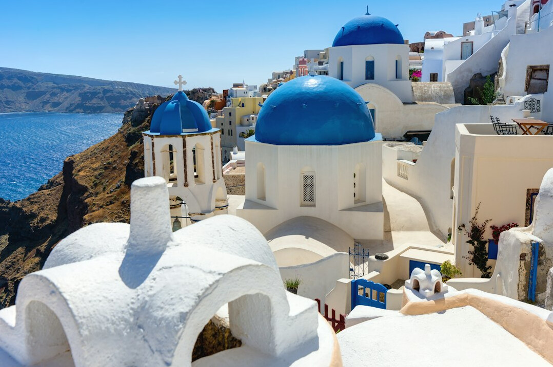 White houses with blue domes in Santorini overlooking the sea
